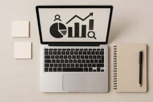 Desk workspace with laptop, sticky notes, and marketing analytics dashboard icons in a clean flat lay