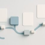 Clean white desk with a laptop showing abstract local map pins and minimalist analytics charts, next to a notebook and smartphone on a cool white workspace.